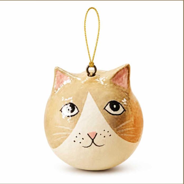 A cat-shaped Christmas ornament with a gold hanging loop, featuring a cream, tan, and brown painted face with black eyes and whiskers