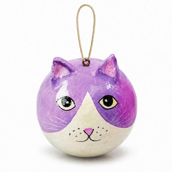 A round, hand-painted cat ornament with a purple and white face, featuring a small gold hanging loop at the top, set against a plain white background.