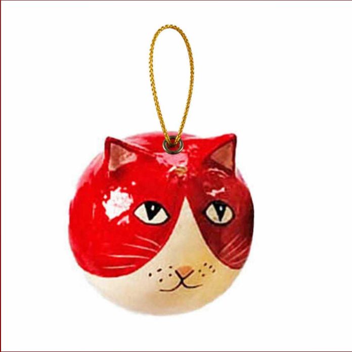 A glossy painted cat-shaped Christmas ornament with a red and cream face, featuring a gold hanging string, shown against a plain white background.