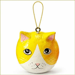 A hand-painted cat head ornament with a yellow and white face, pink ears and nose, and a gold hanging loop, shown on a plain white background.