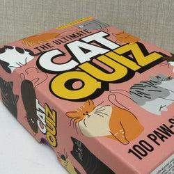 The Ultimate Cat Quiz game box featuring a pink background with colorful cartoon cat illustrations and bold yellow and white title text.