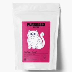 A white coffee bag with a bright pink label  featuring the brand name 'PURRESSO COFFEE' above a white cat, and text 'Cat Nap - Decaf'