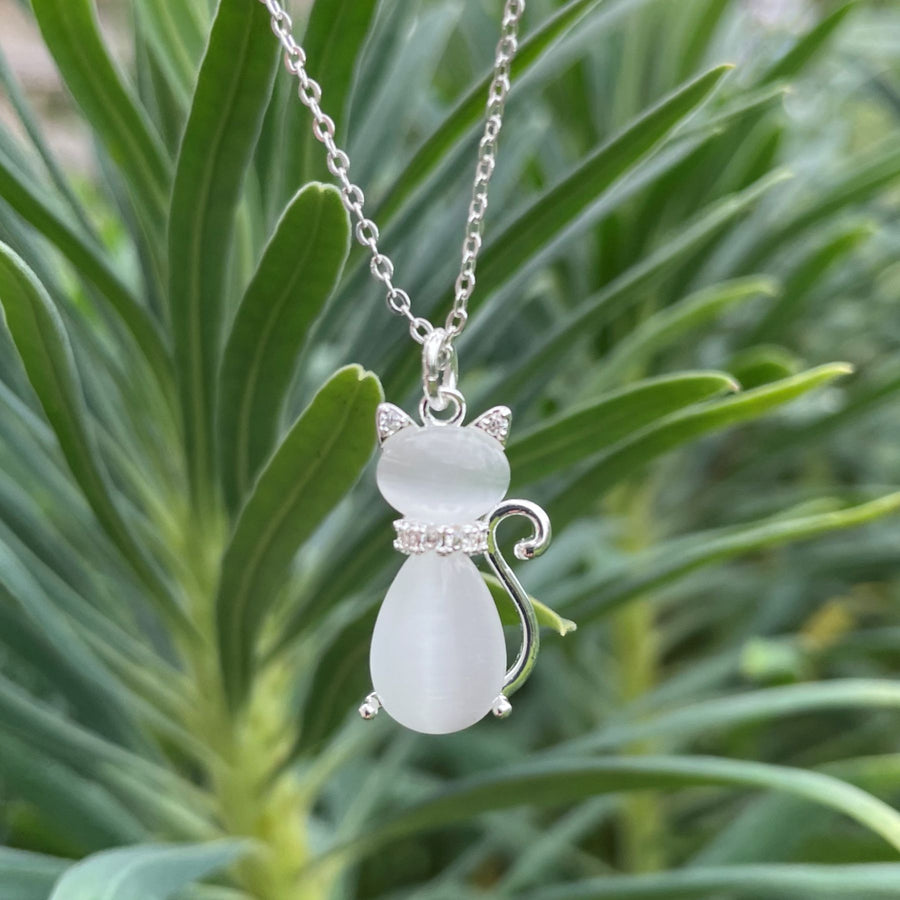 A silver-plated chain necklace with a cat-shaped pendant made of moonstone