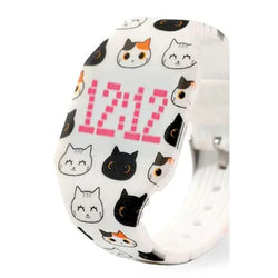 A white silicone watch band featuring a playful pattern of cartoon cat faces in black, white, and orange, with a pink digital display