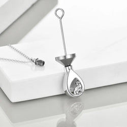 A sterling silver urn pendant necklace with a cat design, silver chain, and funnel