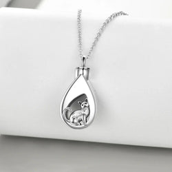 A sterling silver urn pendant necklace with a cat design, attached to a silver chain