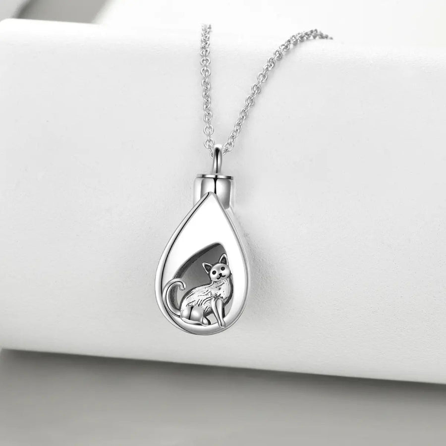 A sterling silver urn pendant necklace with a cat design, attached to a silver chain