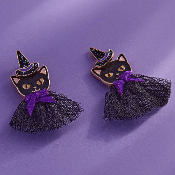 A pair of Halloween-themed cat earrings. The earrings feature a black cat wearing a black glittery witch hat and a black tulle tutu dress 