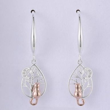 Silver and rose gold earrings on a light grey background