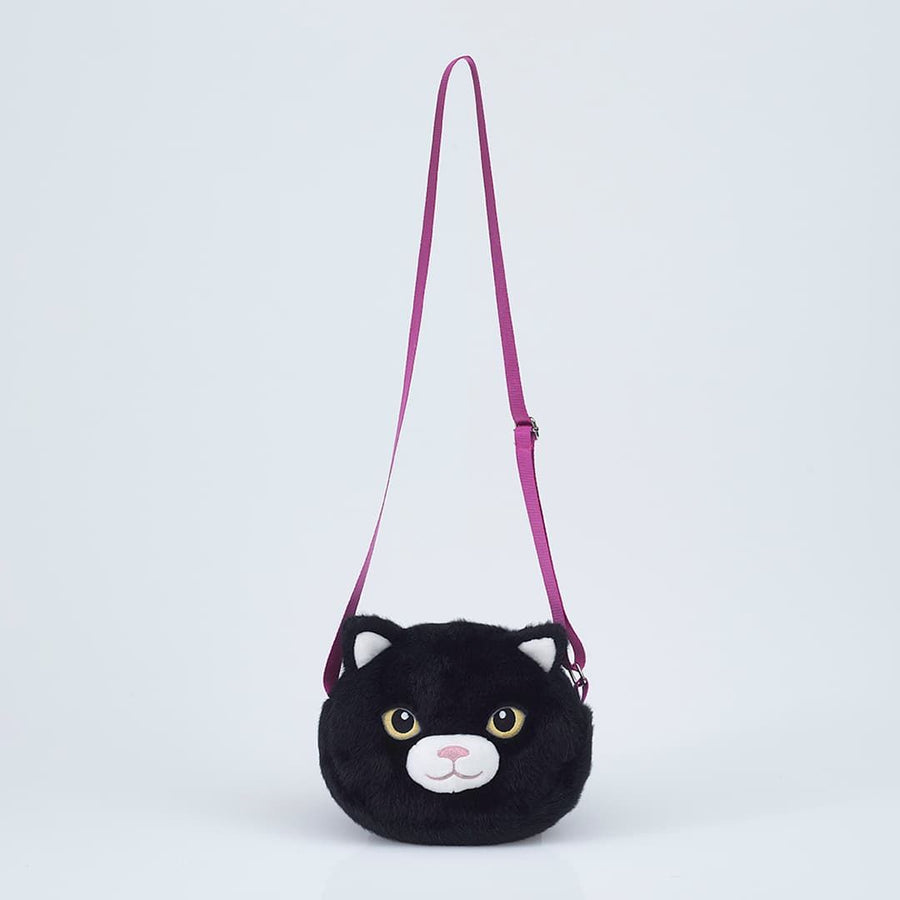A black plush cat-shaped shoulder bag with a magenta strap, featuring embroidered cat eyes and nose
