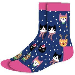 A pair of women's Christmas socks with a navy blue background, white snowflakes, and cartoon cats wearing hats, scarves, and winter clothing. 