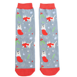 White festive cats socks on a denim blue background. With stars and foliage