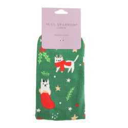 White cats bamboo socks on a green background. With stars and foliage. 