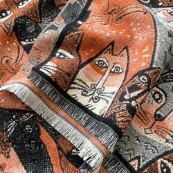 Whimsical Cats Jacquard Scarf in Black and Brown — close-up of woven cat design with fringed ends