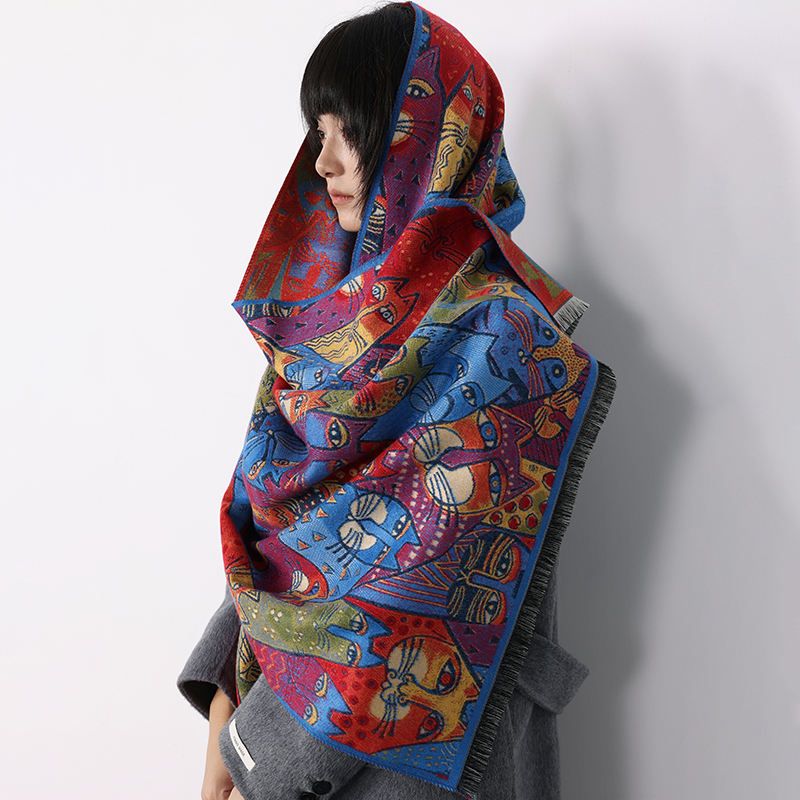 Person wearing a colorful patterned scarf against a plain background