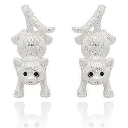 Two silver cat-shaped earrings on a white background