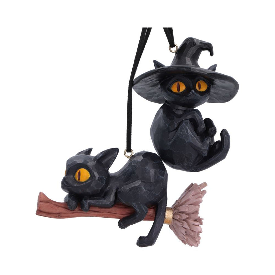 Black cat hanging ornaments shaped like a witch sitting on a broomstick, with glowing yellow eyes and a black hanging cord