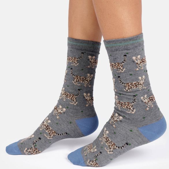 Grey crew socks with a bengal cat print pattern and blue toes and heels, shown on a model's feet