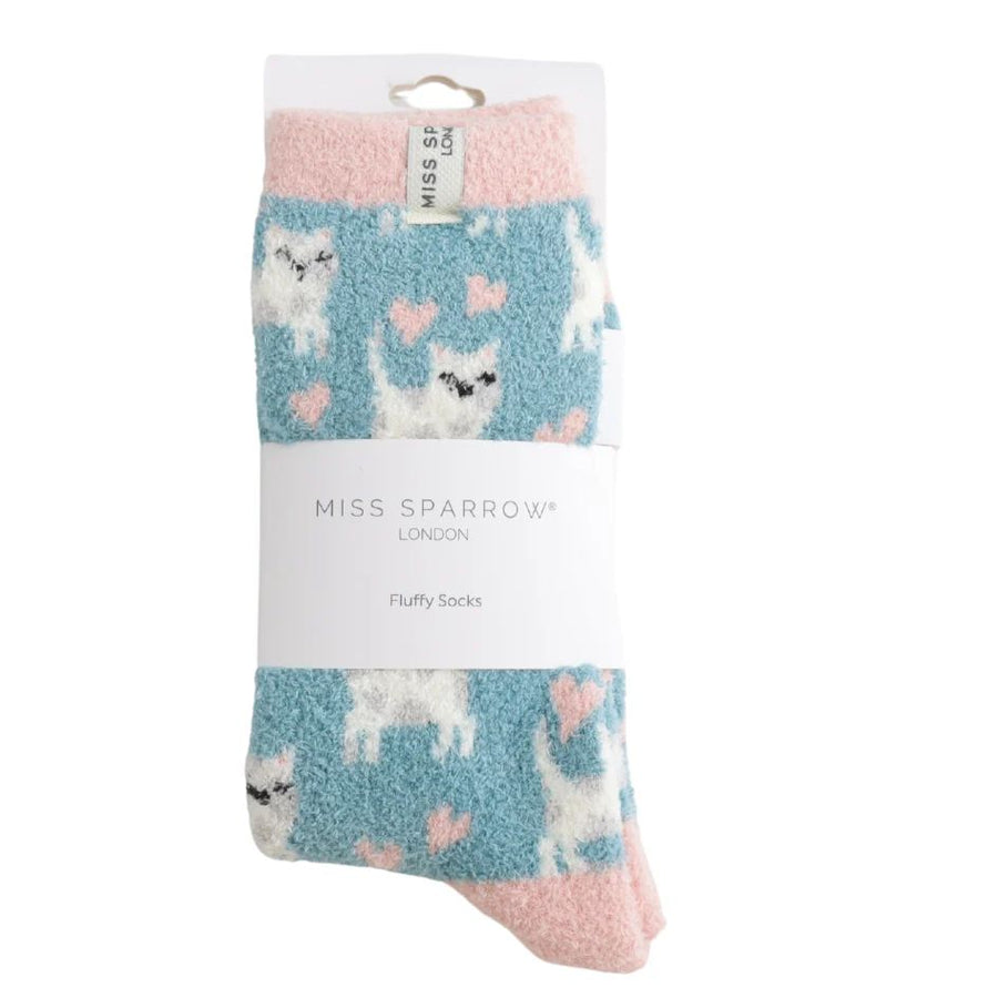 Packaged MISS SPARROW LONDON fluffy socks featuring a light blue background with white cat patterns, pink hearts, and pink cuffs.