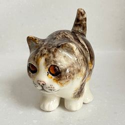 Ceramic cat figurine with a white background