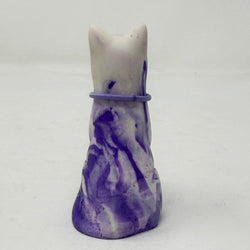A lavender and white and marbled cat figurine wearing a purple collar with a green heart charm. Rear view.