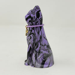 A purple and black marbled cat figurine wearing a purple collar with a gold initial 'P' charm, set against a plain light grey background. Side view.