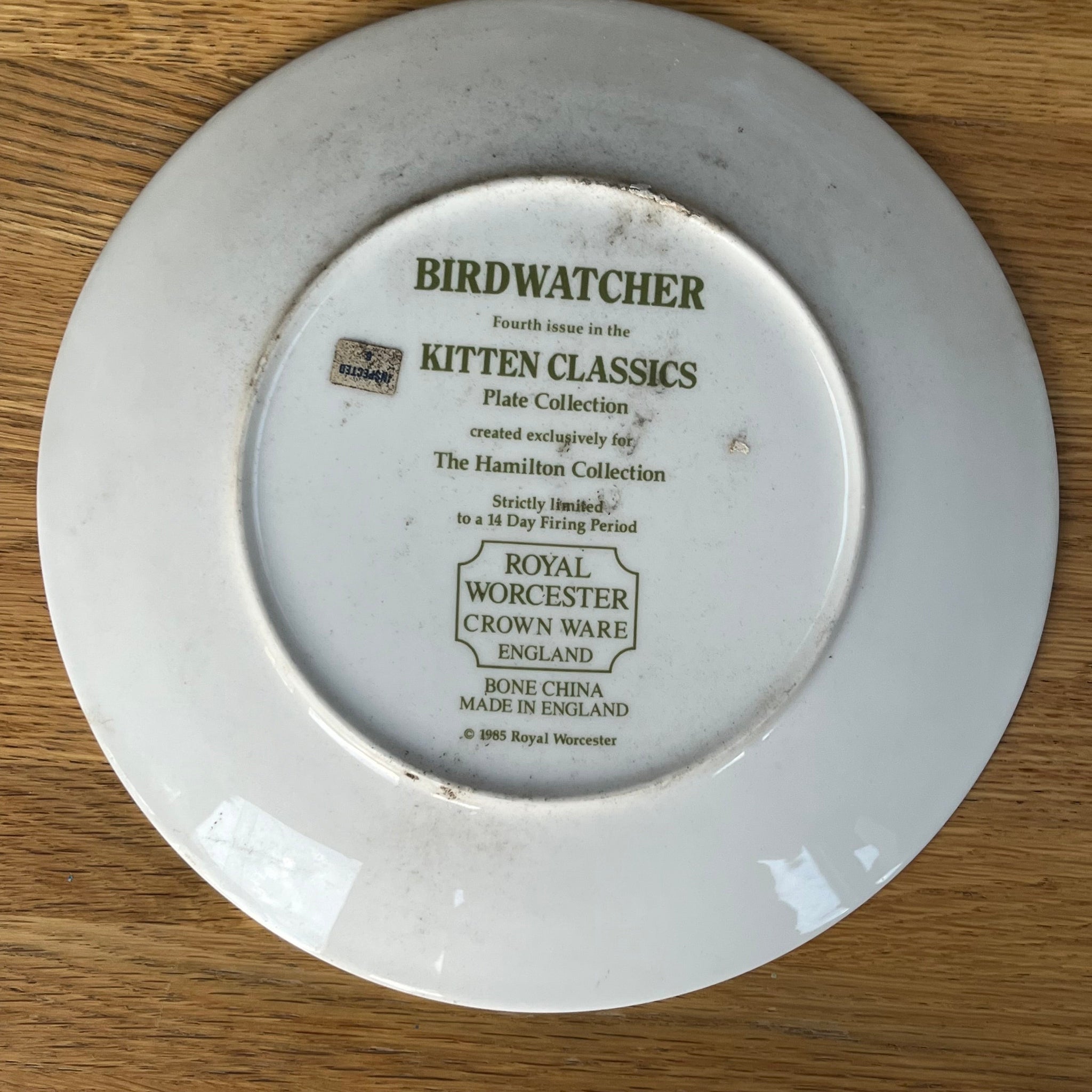 White plate with text on a wooden surface