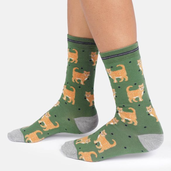 A pair of crew socks, featuring an all-over print of orange tabby cats on a muted green background with small black polka dots