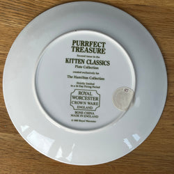 White plate with 'Royal Worcester' branding on a wooden surface