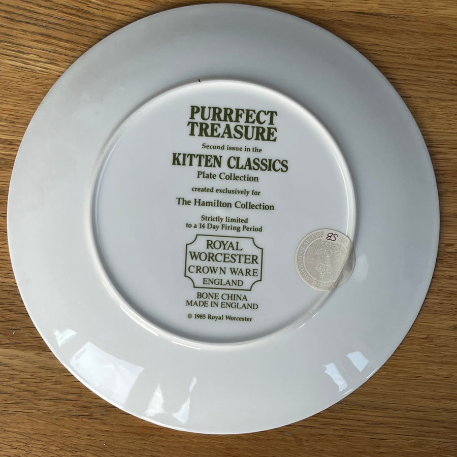 White plate with 'Royal Worcester' branding on a wooden surface