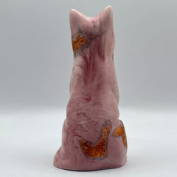 A pink cat figure, featuring natural pink stone marbling and textured metallic gold inclusions, shown against a neutral grey background.