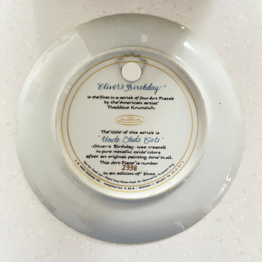 Round white plate with text and a gold rim on a white background