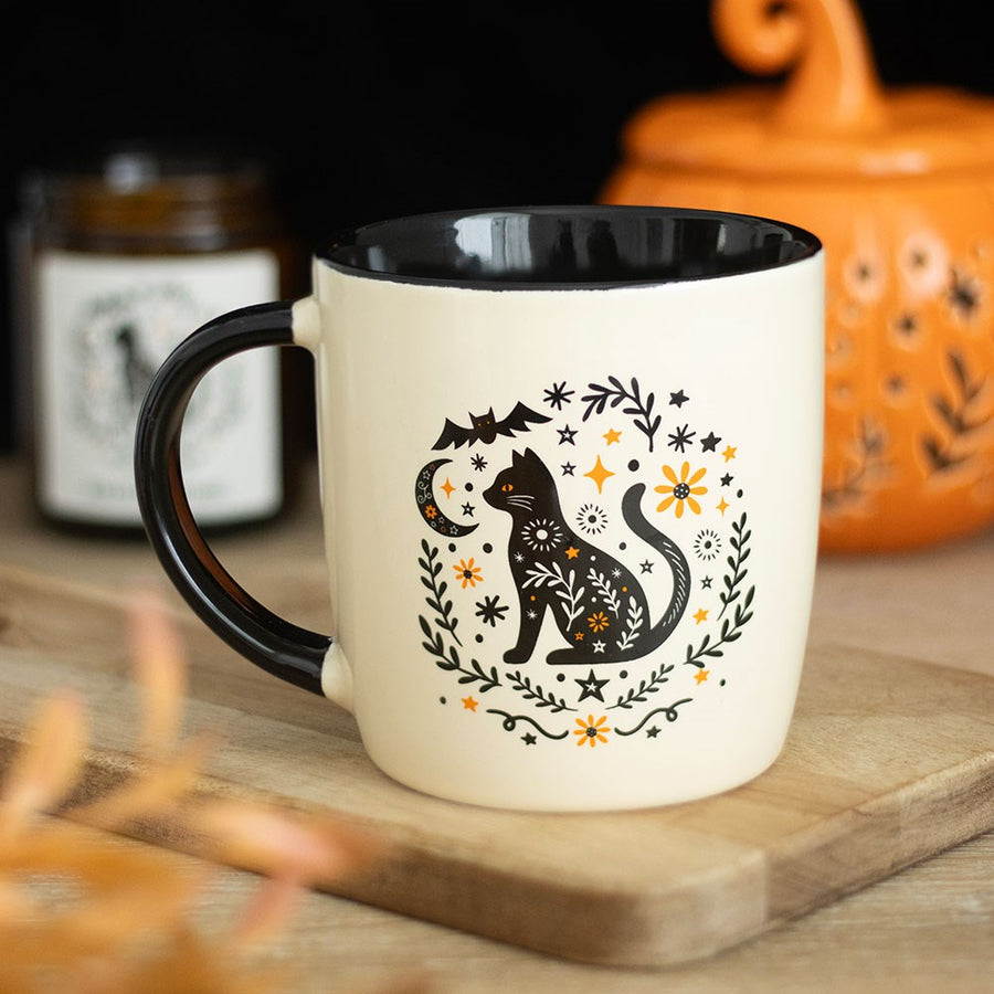 Frightful Folk Cat Mug with folk art black cat, moon, bat and floral design, cream ceramic with black handle and interior