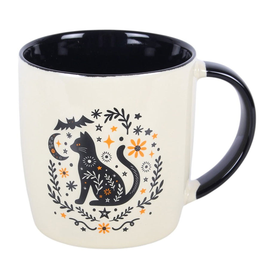 Frightful Folk Cat Mug front view showing folk art black cat with stars, moon and orange flowers on cream ceramic