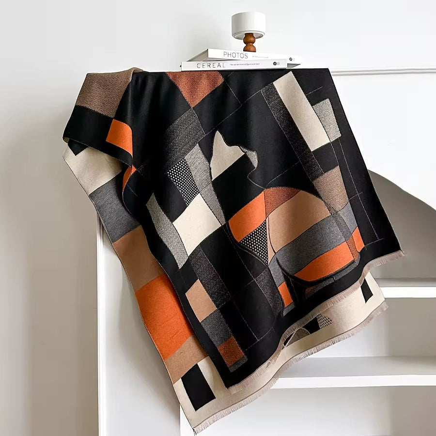 Patterned blanket draped over a chair with a white background