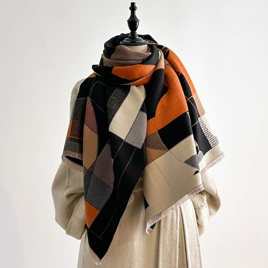 Plaid scarf draped over a mannequin with a plain background