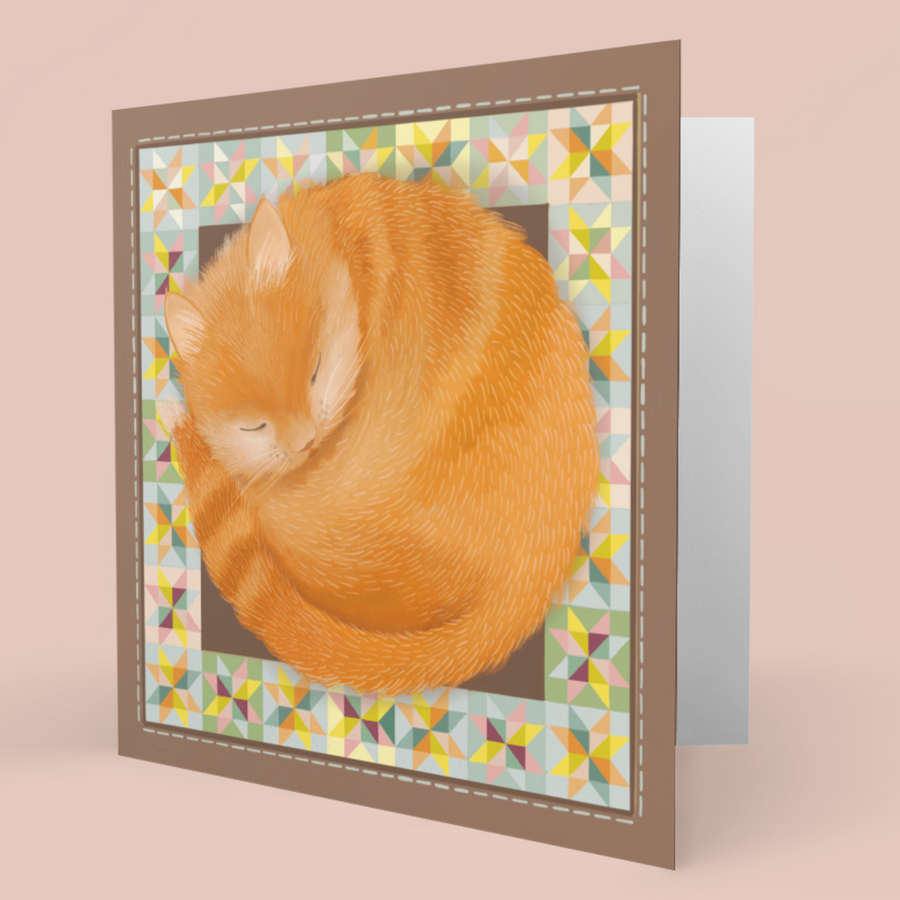 A square greeting card featuring a curled-up orange tabby cat illustration, shown standing against a soft peach background