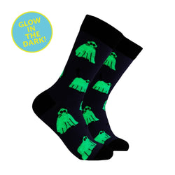 A pair of black crew socks with a repeating bright green ghost pattern, shown on a plain white background with a blue circular badge that reads 'GLOW IN THE DARK!'.