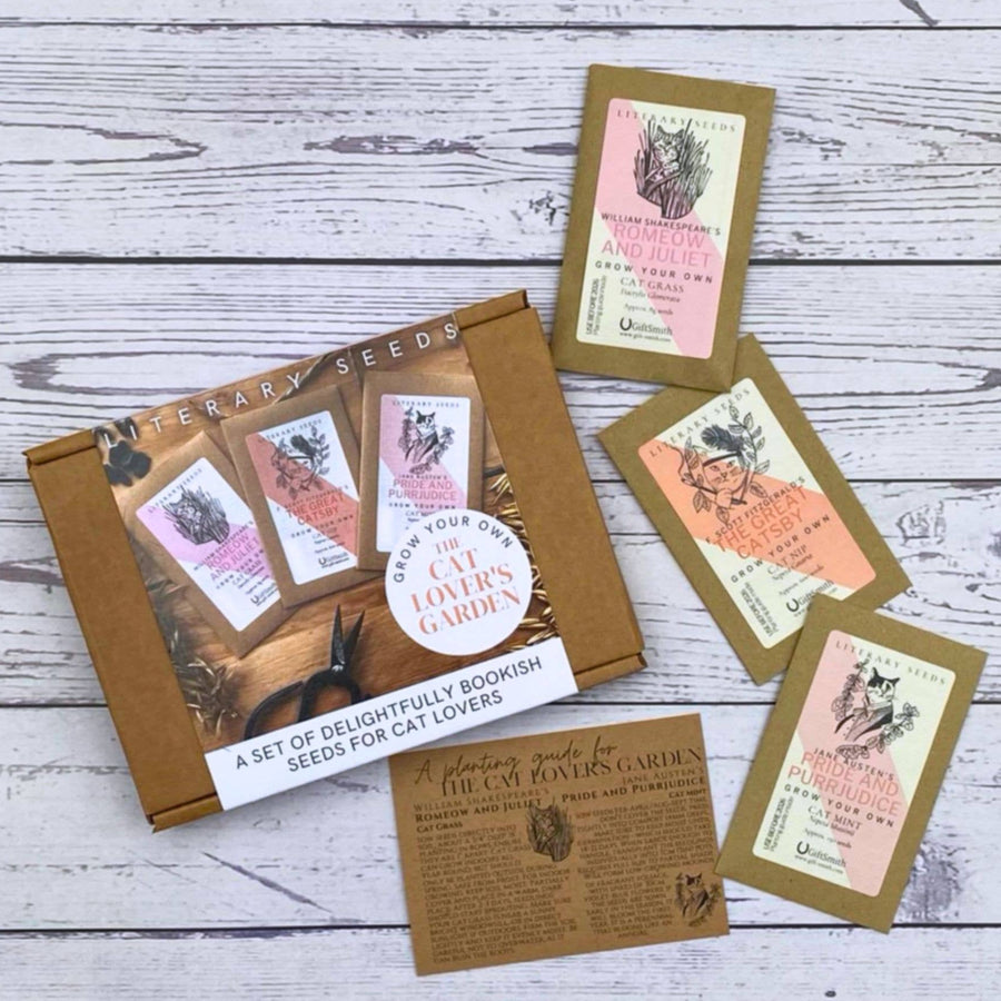 A boxed set of literary seeds for cat lovers. A cardboard box with printed illustrations, along with three small seed packets