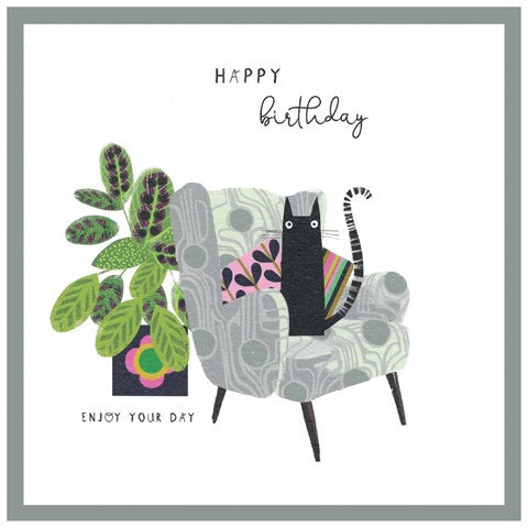 Happy Birthday card featuring a black cat in a grey armchair