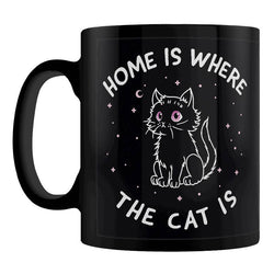 A black ceramic mug with a white line-art illustration of a cat and the text 'HOME IS WHERE THE CAT IS'