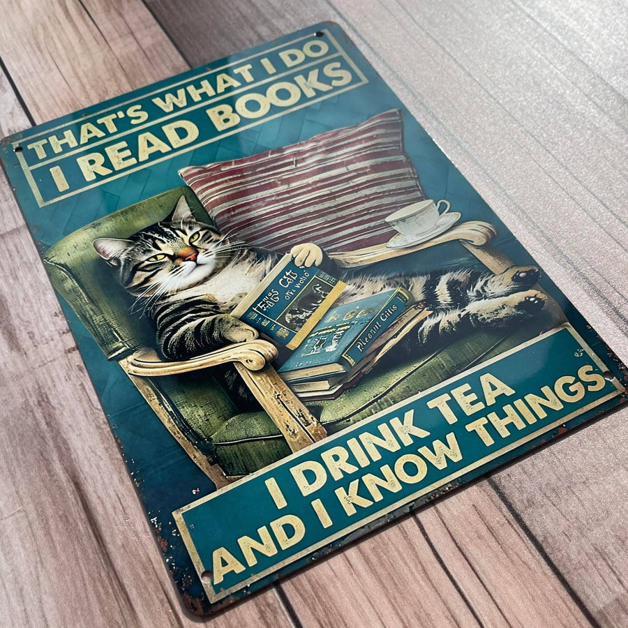Decorative sign with a cat reading a book, text 'That's what I do I read books I drink tea and I know things'
