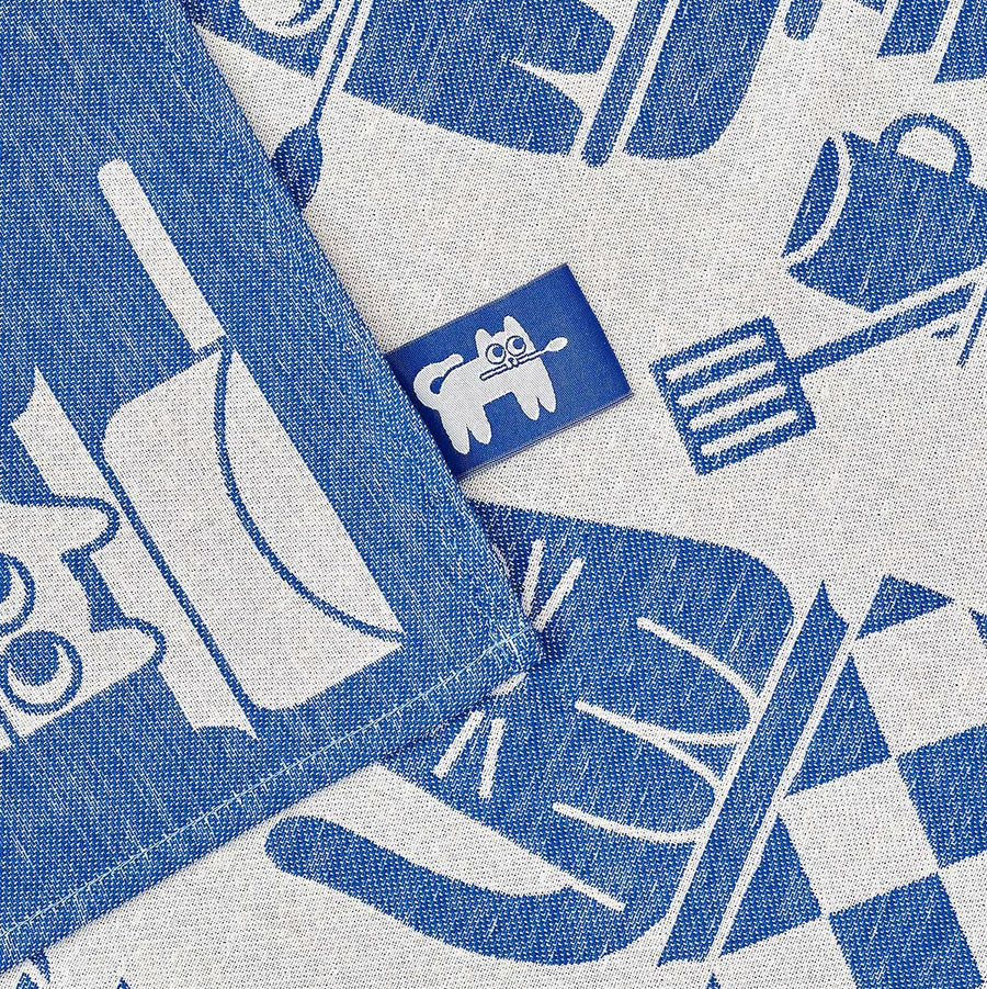 Blue and white cats patterned fabric with a cat logo in the centre