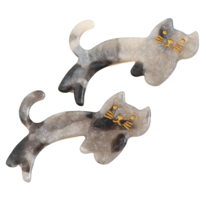 Two tortoiseshell cat-shaped hair clips on a plain white background.