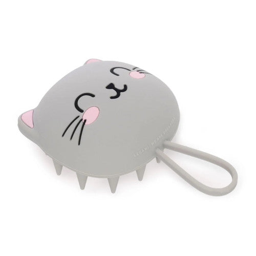 A grey cat-shaped hairbrush / scalp massager with pink ear tips, pink cheeks, and black facial features