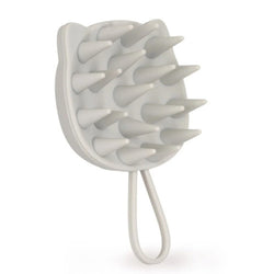 A light grey silicone grooming brush for humans with long conical bristles and a loop handle
