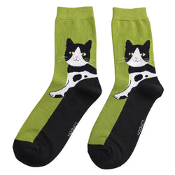 Two lime green and black socks with a happy tuxedo cat design.