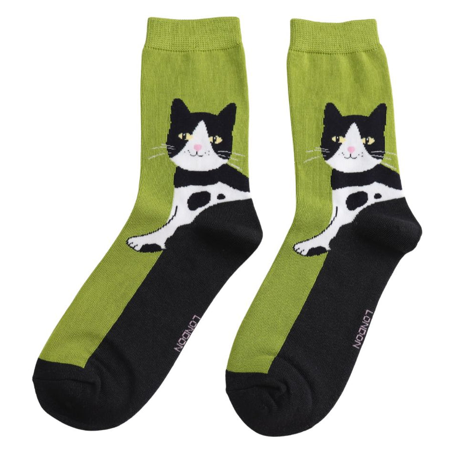 Two lime green and black socks with a happy tuxedo cat design.