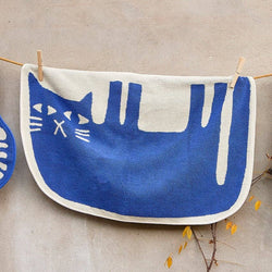 Blue cat on its side on a white background hanging on a line