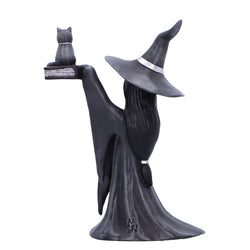 Statue of a witch with a broomstick on a black background